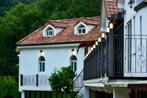 a white house with a red roof and a balcony at Haneulbit gwangang nongwon in Chuncheon