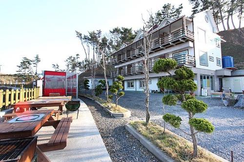 a building with tables and benches in front of it at Blue Heights in Boryeong