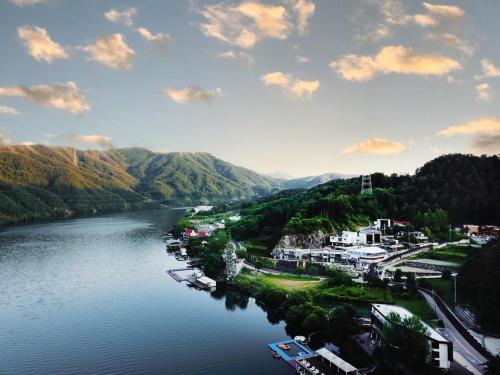 a view of a river with houses and a town at Vine family and kids four season pool villa in Gapyeong