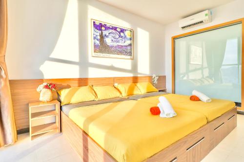 a bedroom with a large yellow bed in a room at Classy Home - CSJ Tower Vũng Tàu, Luxury, Sky-Sea View and Walk-To-Beach in Xã Thang Tam