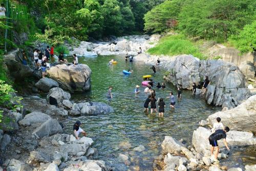 a group of people swimming in a river at Gapyeong Yongchu Sarang Pension in Gapyeong
