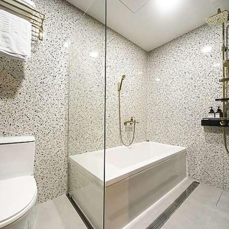 a bathroom with a shower and a tub and a toilet at Browndot Hotel Godeok newtown in Pyeongtaek
