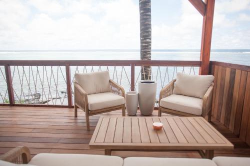 a balcony with two chairs and a table on a boat at Chantauvent Guest House in Blue Bay