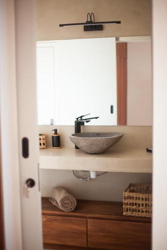 a bathroom with a bowl sink on a counter at Chantauvent Guest House in Blue Bay