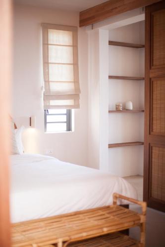 a bedroom with a white bed and a window at Chantauvent Guest House in Blue Bay