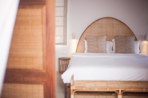 a bedroom with a large bed with a wooden headboard at Chantauvent Guest House in Blue Bay