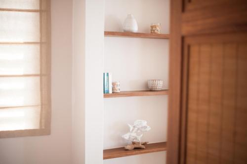 a shelf with a teddy bear sitting on it at Chantauvent Guest House in Blue Bay