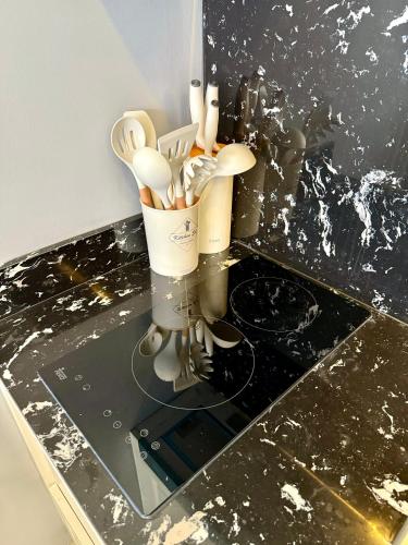 a container of utensils sitting on a counter at Poolside 1 Bedroom Apartment by Renttini in Surin Beach