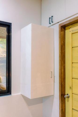 a white cabinet in a room with a window at Busai Dream Falls Resort in Loboc
