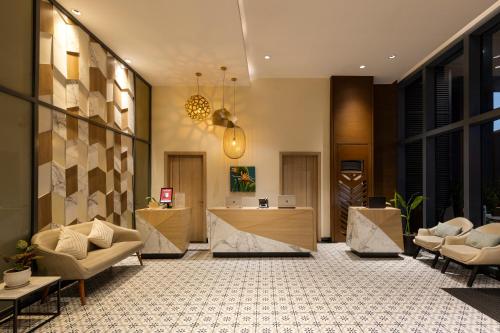 a lobby with chairs and a reception desk at Summit Hotel Greenhills in Manila