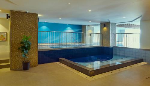 a large bathroom with a large blue tub at Summit Hotel Greenhills in Manila