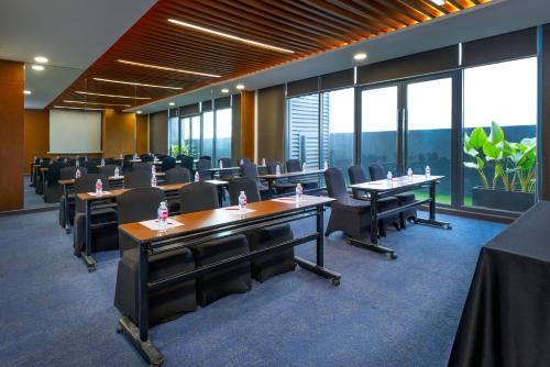 a conference room with tables and chairs and windows at Summit Hotel Greenhills in Manila