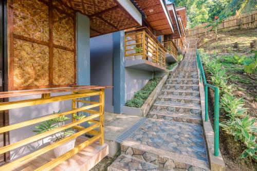 a set of stairs leading up to a house at Busai Dream Falls Resort in Loboc