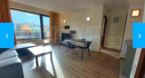 a living room with a table and a couch at Terra Complex SPA apartment 1 bedroom suite in Razlog