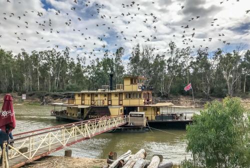 a large yellow boat is docked on a bridge at Pastoral Hotel Motel Echuca CBD in Echuca