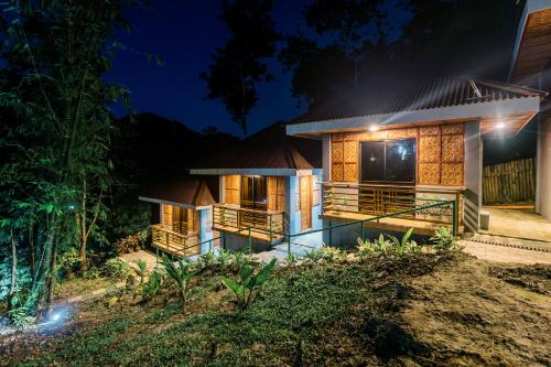 a house at night with lights at Busai Dream Falls Resort in Loboc
