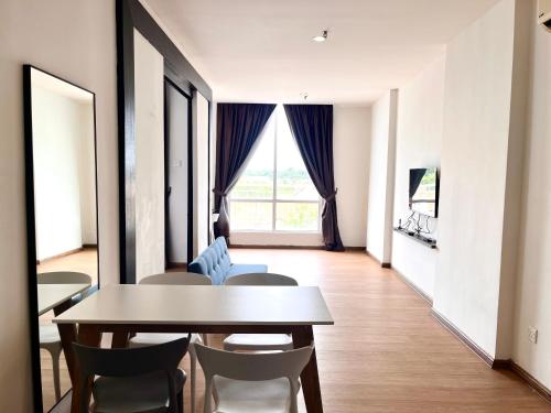a dining room with a table and chairs at Hillton Suites in Ayer Keroh