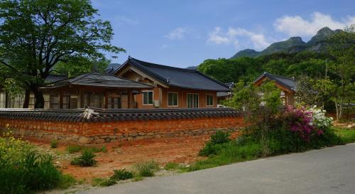 a house with a brick wall next to a street at Buan Dream of Butterfly Pension in Buan