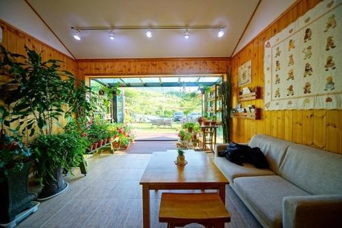 a living room with a couch and a table at Pension on the Sea Shore in the Bosom Department Byeonsanbando in Buan