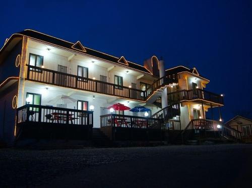 a large white building with umbrellas in front of it at Anmyeondo Taean Romance Pension in Taean