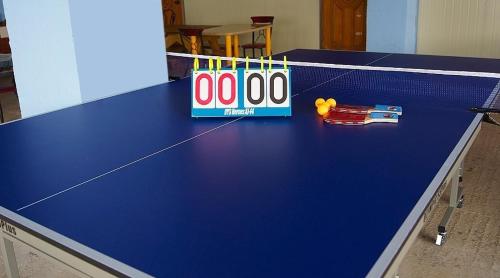 a blue ping pong table with a ping pong racket at Buan Jeonmang Joeun Pension in Buan