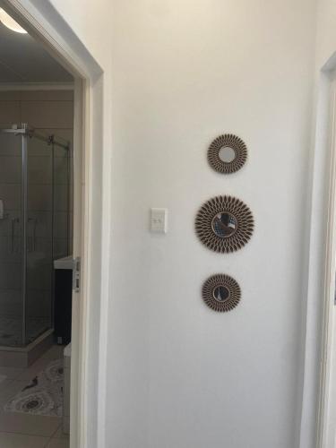 two mirrors on a wall in a bathroom at Classy and Cozy 2 in Fourways
