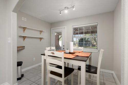 a dining room with a table and chairs at Modern rustic home in Olmito