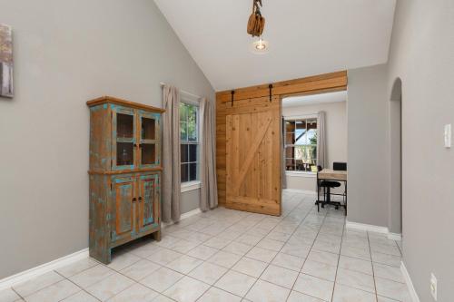 a room with a wooden cabinet and a table at Modern rustic home in Olmito