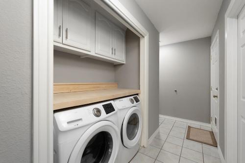 a laundry room with a washer and dryer at Modern rustic home in Olmito