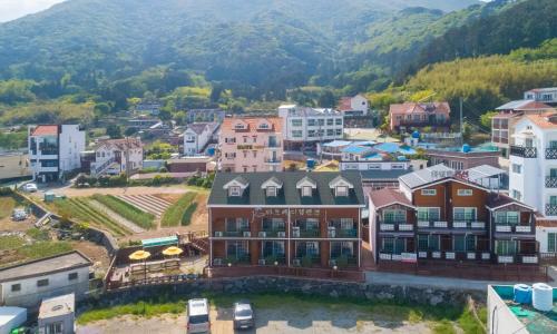 an aerial view of a small town in the mountains at Geoje carpediem pension in Geoje 