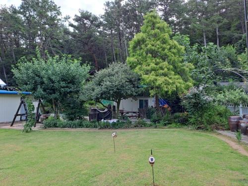 a yard with a park with a playground at Private pension Jeongwonchae in Wanju