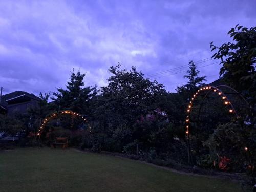 a garden with two arches and lights in a yard at Private pension Jeongwonchae in Wanju
