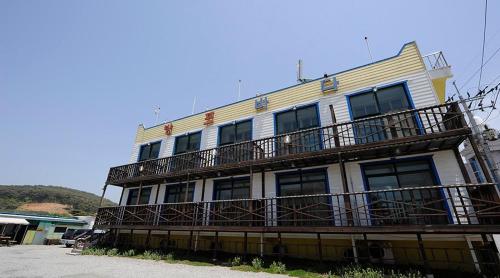 a building with a balcony on the side of it at Bangpo Sea Pension in Taean