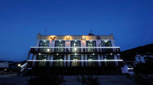 a large building with lights on it at night at Bangpo Sea Pension in Taean