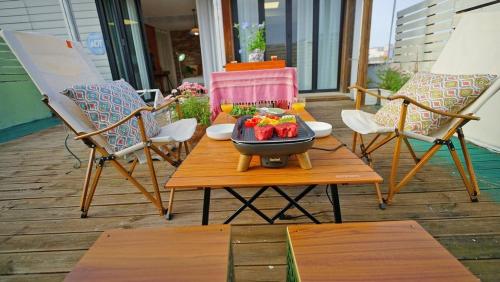 a table with a bowl of fruit on a patio at Jeonju Hanok Village Dohwaseoga Stay Private Pension in Jeonju
