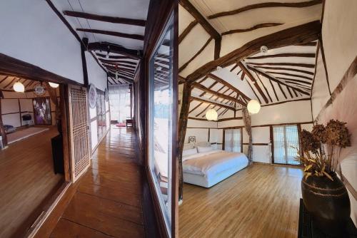 a bedroom with a bed in the middle of a room at Hue Hanok Guesthouse in Buan