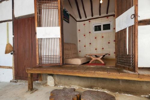 a living room with a couch and a table at Hue Hanok Guesthouse in Buan