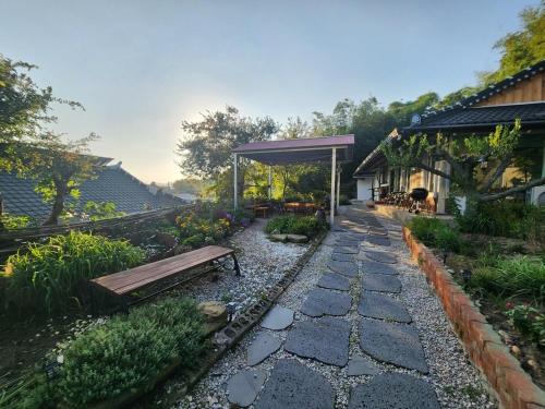 a bench sitting in the middle of a garden at Hue Hanok Guesthouse in Buan