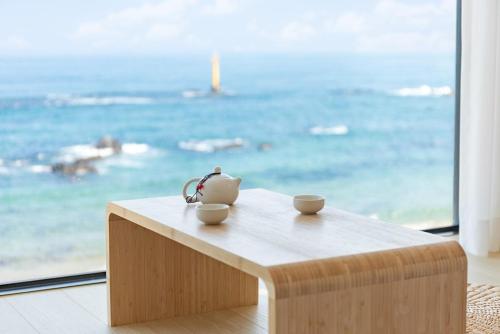 a tea pot sitting on a table in front of a window at Donghae Eodaleul Damda in Donghae