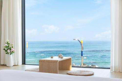 a room with a large window with a view of the ocean at Donghae Eodaleul Damda in Donghae