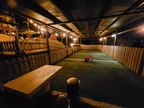 a dark room with a wooden bench and some sheep at Gapyeong Petmily Dog Pension in Gapyeong