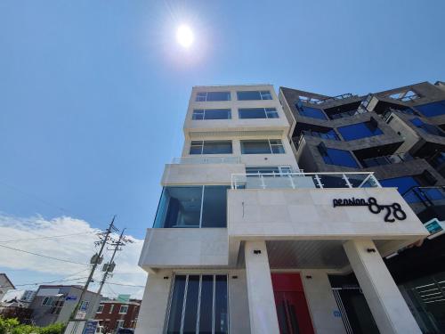 a tall building with a sign on it at Sokcho 828 Spa Pension in Sajin
