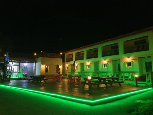 a group of tables and benches in front of a building at night at Gangreung refresh odaesanjeom in Gangneung