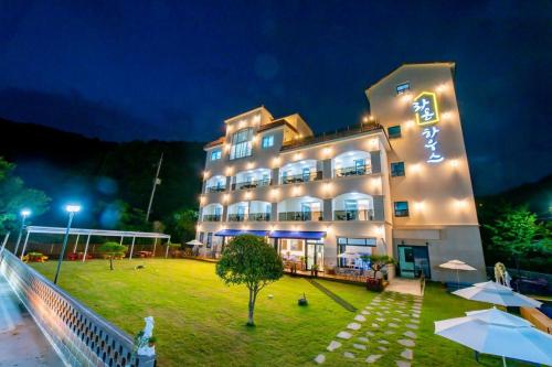a large building with lights on it at night at Suncheon raon house egyeon pension in Suncheon