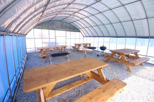 a group of picnic tables in a tent at Mongsanpo High Beach Pension in Taean