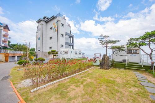 a white building with flowers in front of it at Samcheok eastocean in Samcheok