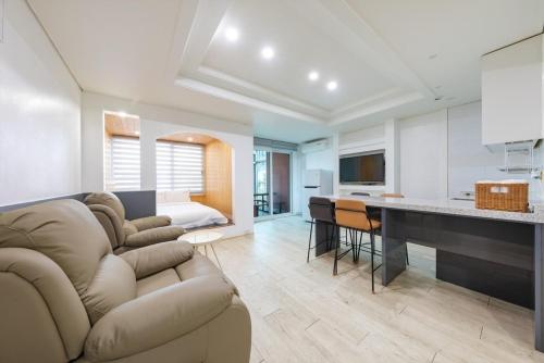 a large living room with a couch and a kitchen at Gyeongju Cookie and Jelly Pension in Gyeongju