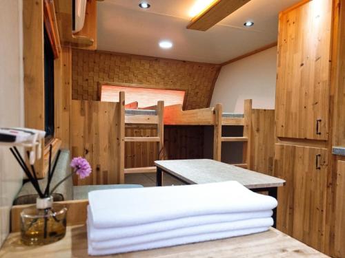a room with a table and some bunk beds at Forest Caravan Pension Incheon in Incheon