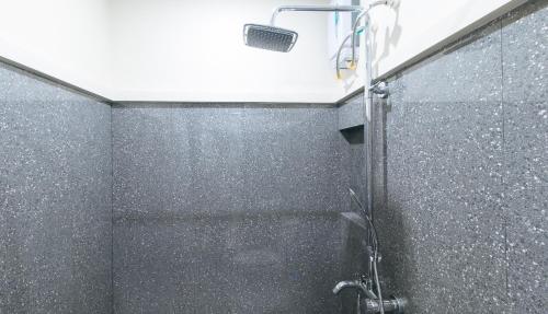 a shower with a glass door in a bathroom at Sunny Day Residences Antipolo in Antipolo