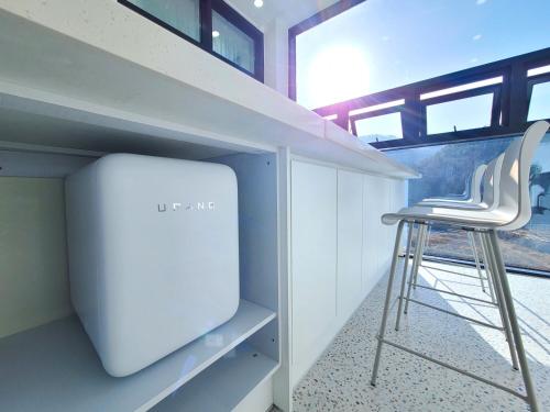 a stool sitting in a room with a tv at Gapyeong Turu Kids Poolvilla in Gapyeong